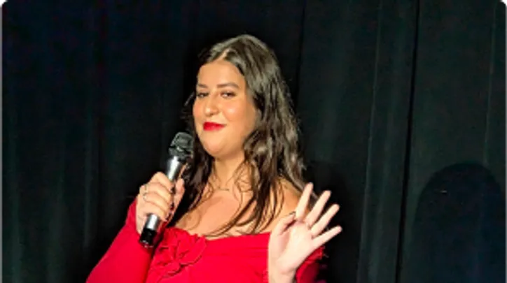 A woman killing it at her standup student showcase.